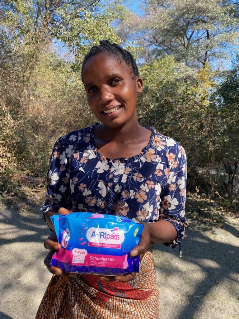 Happy girl showing off her AFRIpads reusable sanitary pads in Zambia