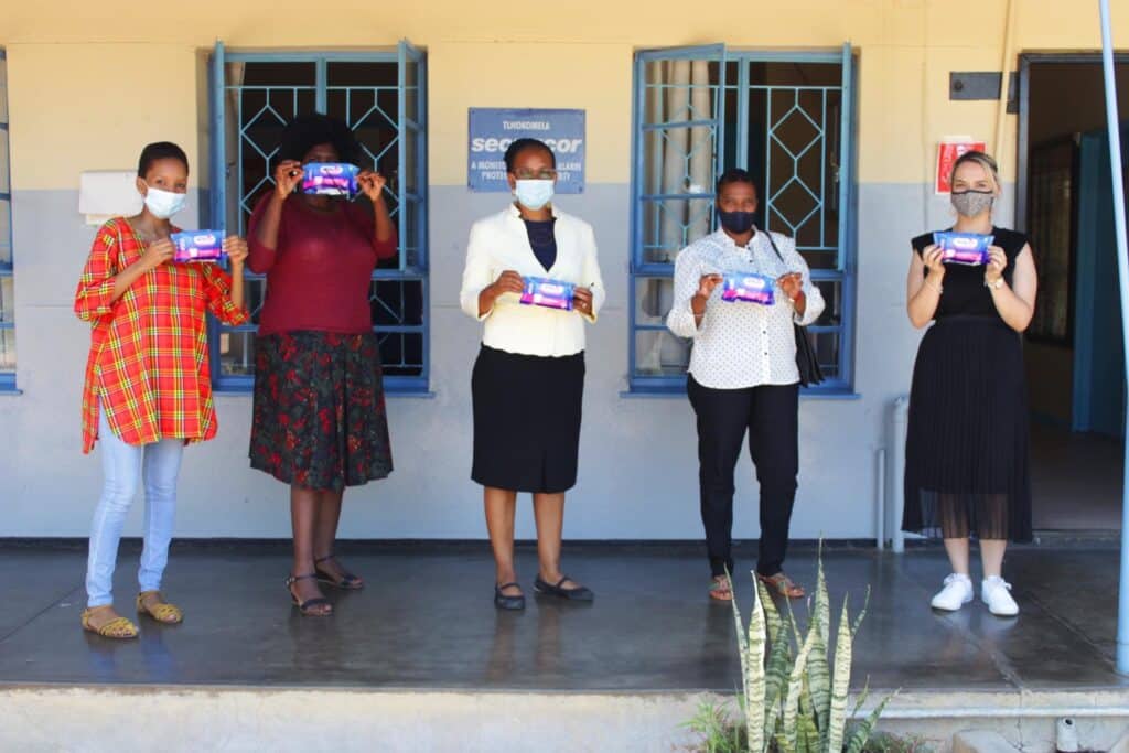 The staff of Phetogo BW and beneficiaries carrying AFRIpads Menstrual Kits