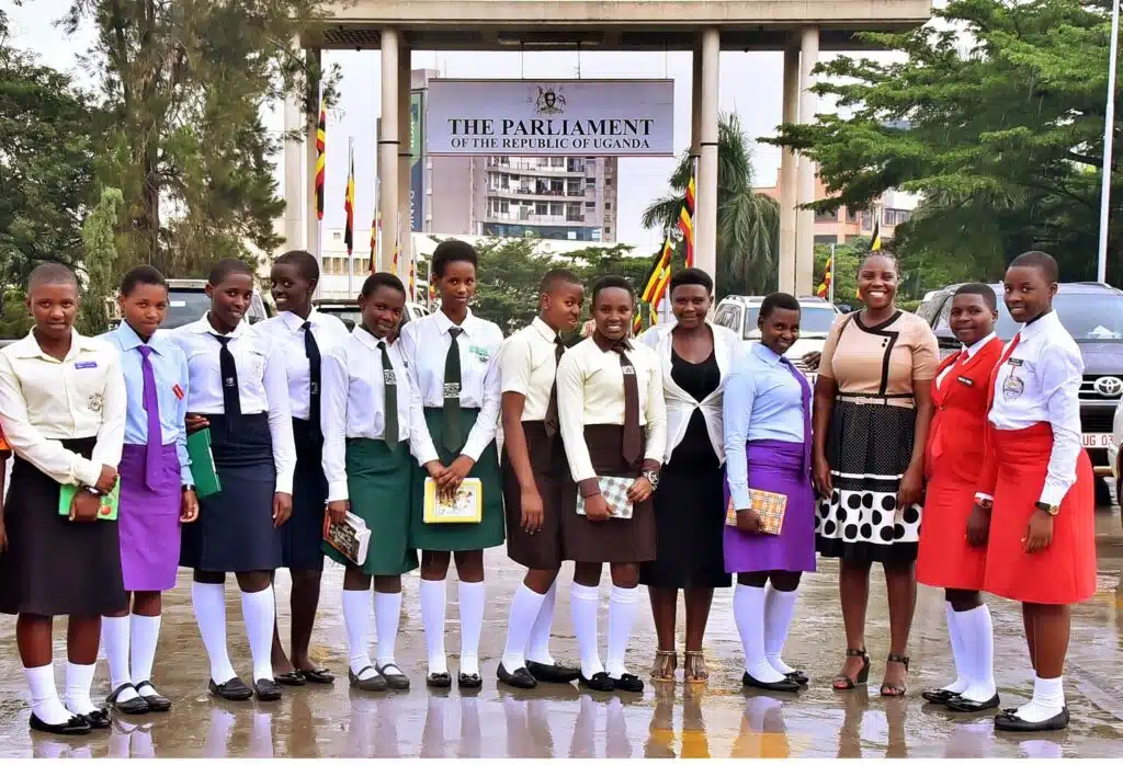 Girls to Lead Africa Leadership Academy Delegates pose in front of the Parliament of Uganda